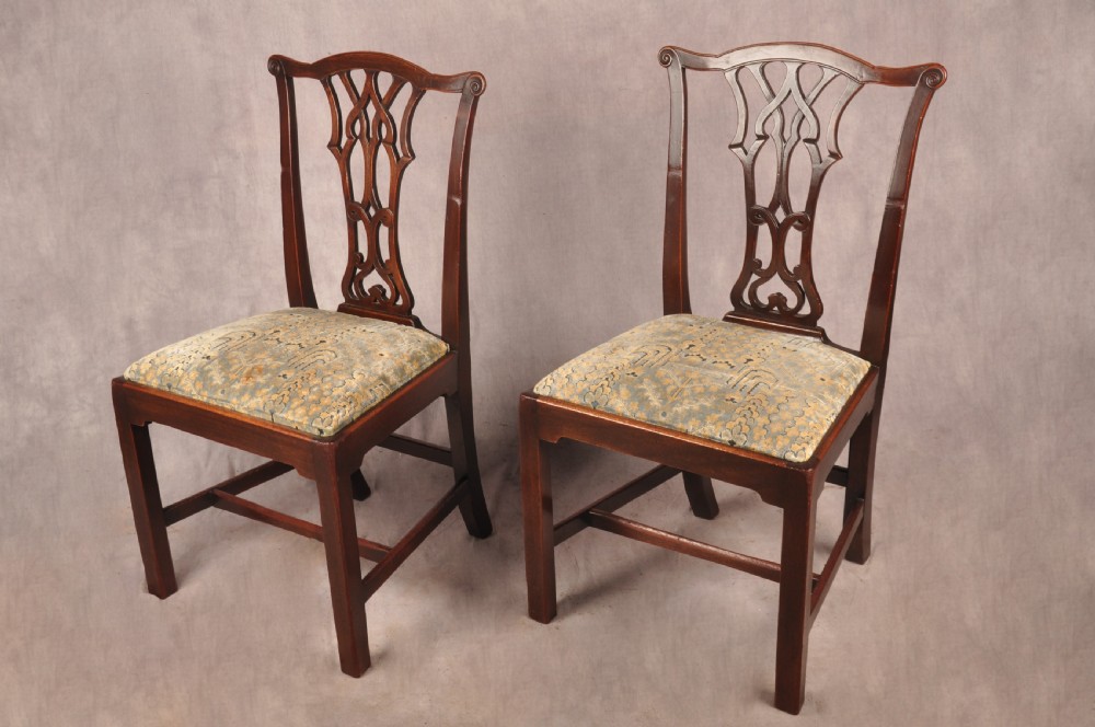 A set of six mahogany Chippendale style dining chairs featuring intricate pierced back splats and patterned upholstered drop-in seats. View II