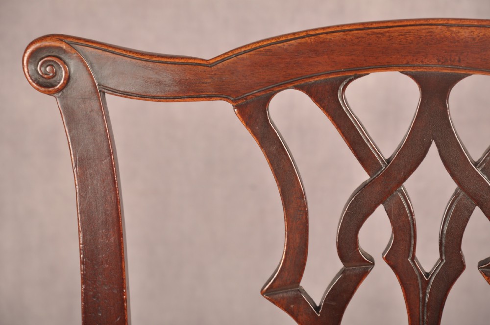 A set of six mahogany Chippendale style dining chairs featuring intricate pierced back splats and patterned upholstered drop-in seats. View VIII