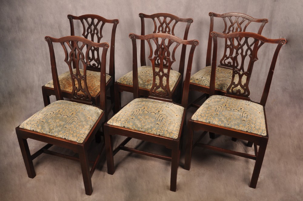 A set of six mahogany Chippendale style dining chairs featuring intricate pierced back splats and patterned upholstered drop-in seats. View XI