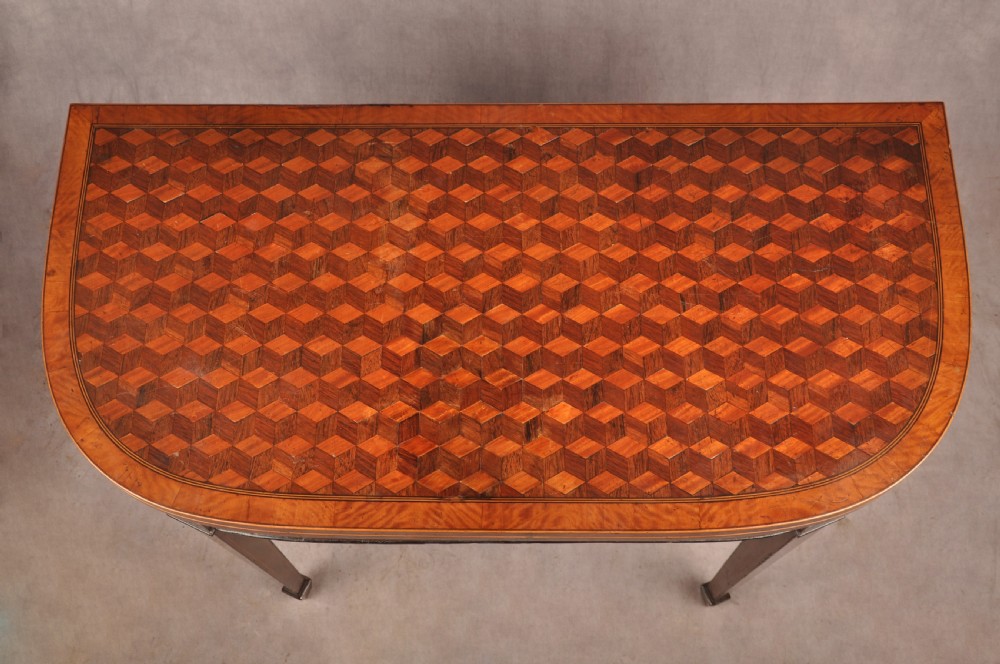 An 18th-century demilune card table featuring a geometric parquetry top, inlaid apron, and four square tapered legs ending in spade feet. View II