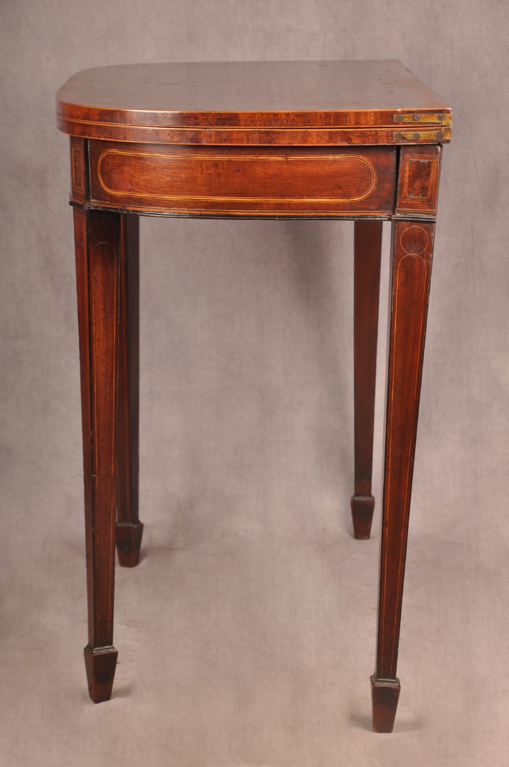 An 18th-century demilune card table featuring a geometric parquetry top, inlaid apron, and four square tapered legs ending in spade feet. View XIV