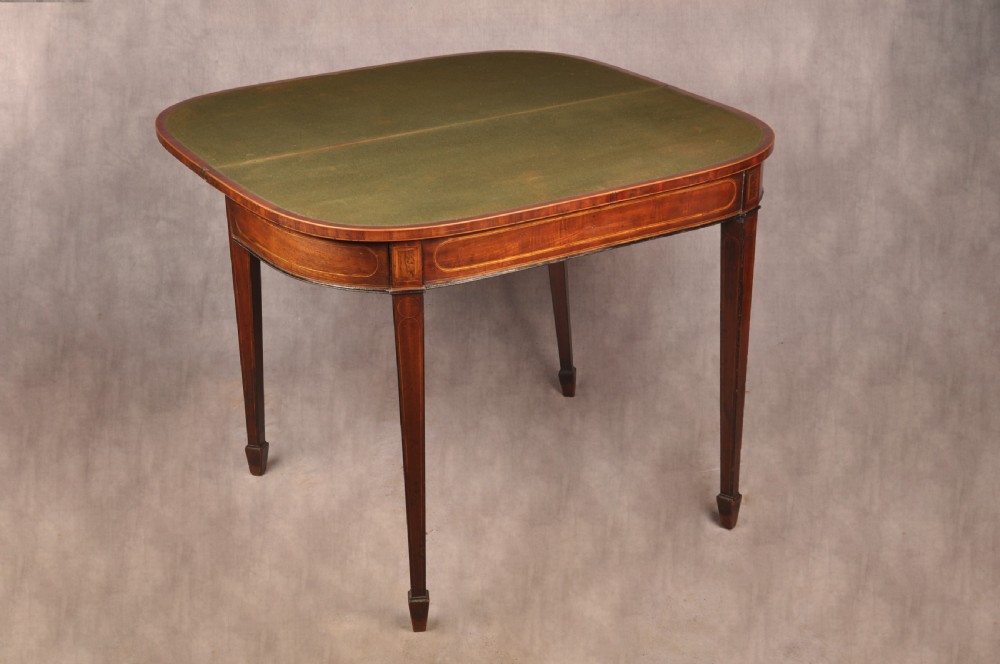 An 18th-century demilune card table featuring a geometric parquetry top, inlaid apron, and four square tapered legs ending in spade feet. View XVII