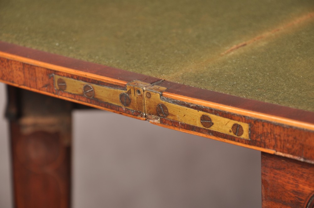 An 18th-century demilune card table featuring a geometric parquetry top, inlaid apron, and four square tapered legs ending in spade feet. View XVIII
