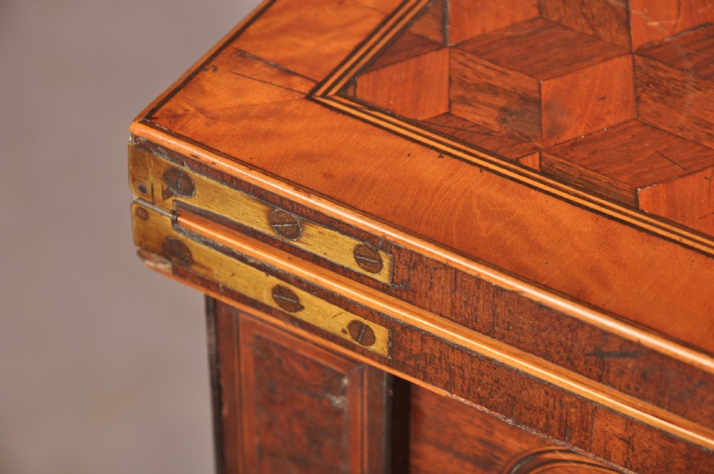 An 18th-century demilune card table featuring a geometric parquetry top, inlaid apron, and four square tapered legs ending in spade feet. View XIX