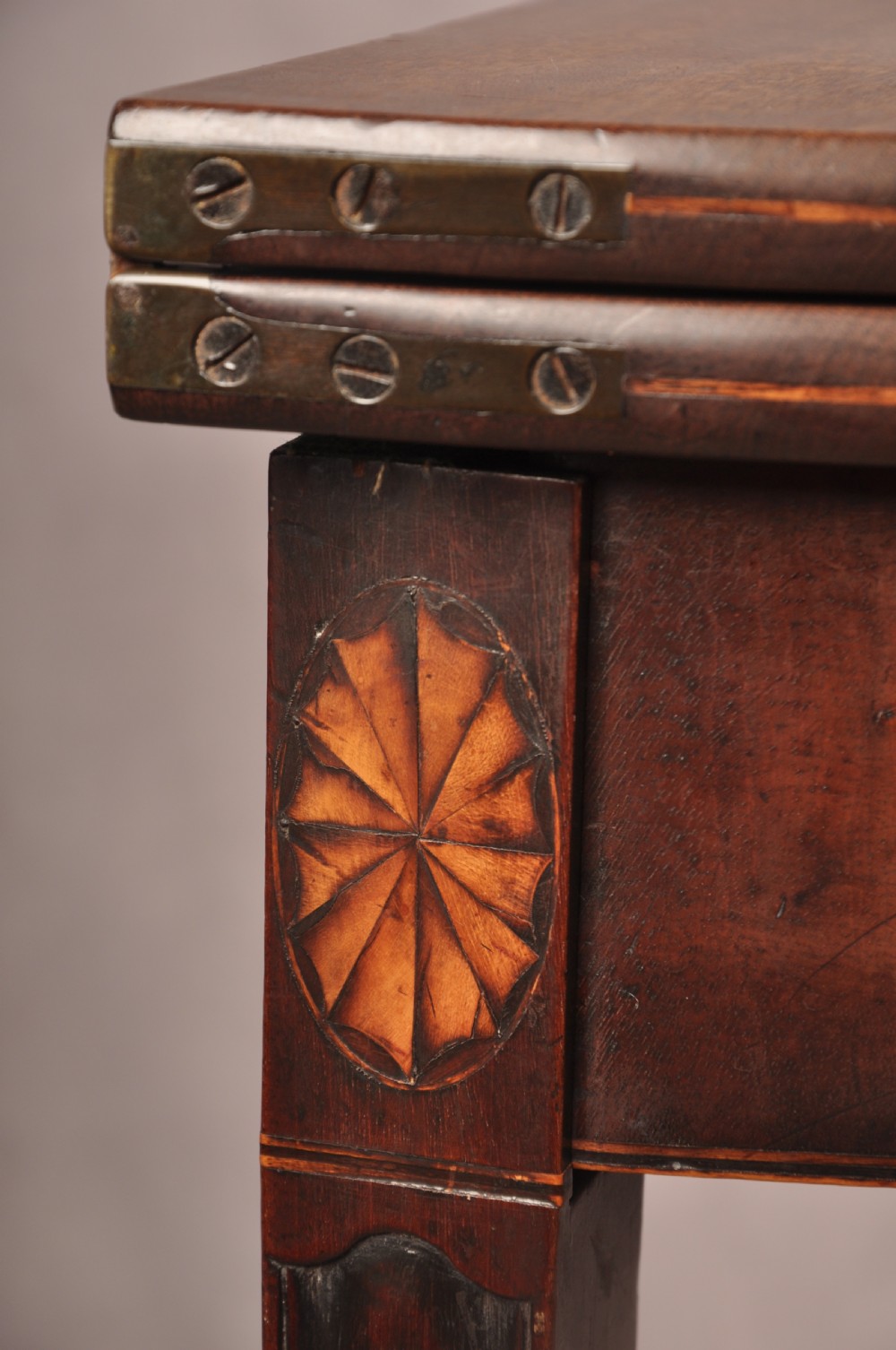 An 18th-century demilune mahogany tea table featuring tapered legs with inlaid patera motifs and spade feet. View XII