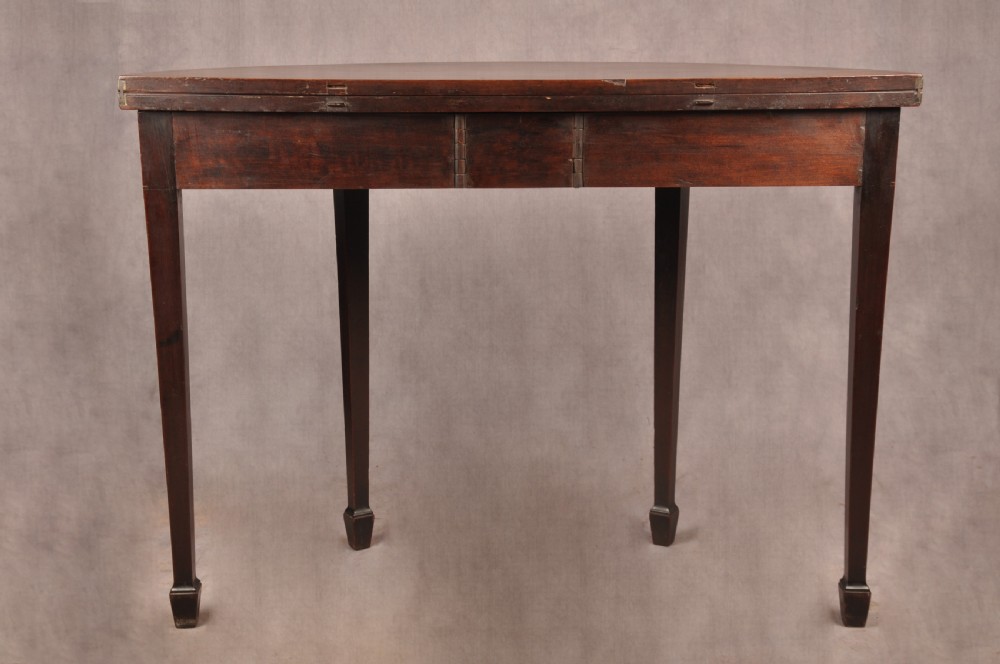 An 18th-century demilune mahogany tea table featuring tapered legs with inlaid patera motifs and spade feet. View XIII