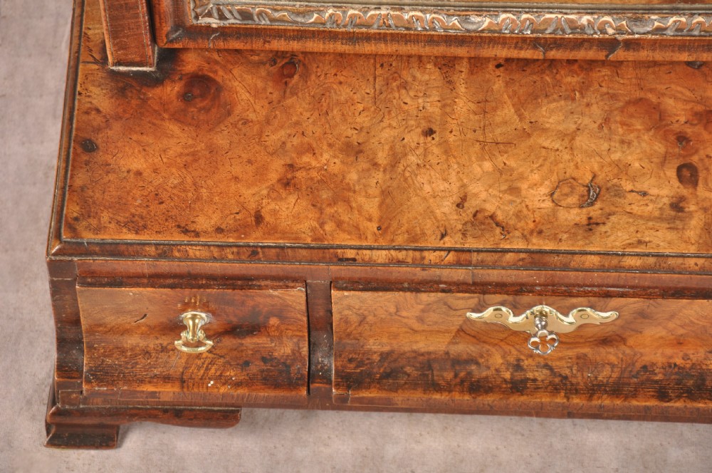 An 18th-century walnut toilet mirror featuring a rectangular adjustable glass frame resting above a three-drawer box base with brass handles. View V