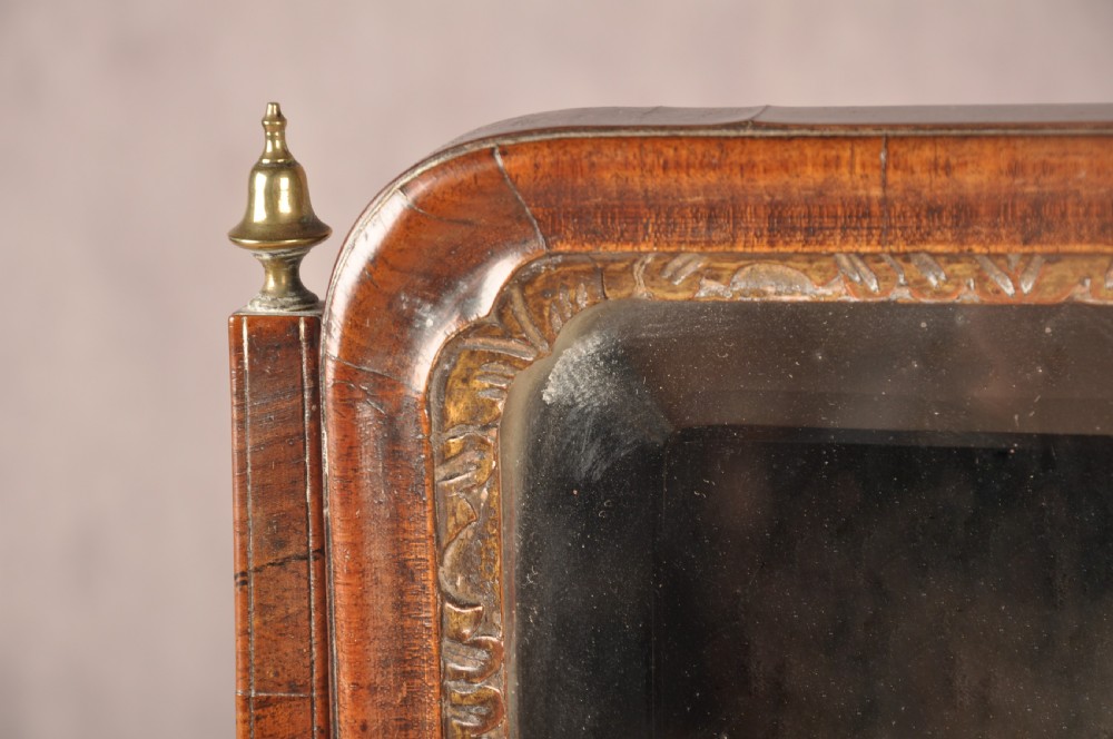 An 18th-century walnut toilet mirror featuring a rectangular adjustable glass frame resting above a three-drawer box base with brass handles. View IX