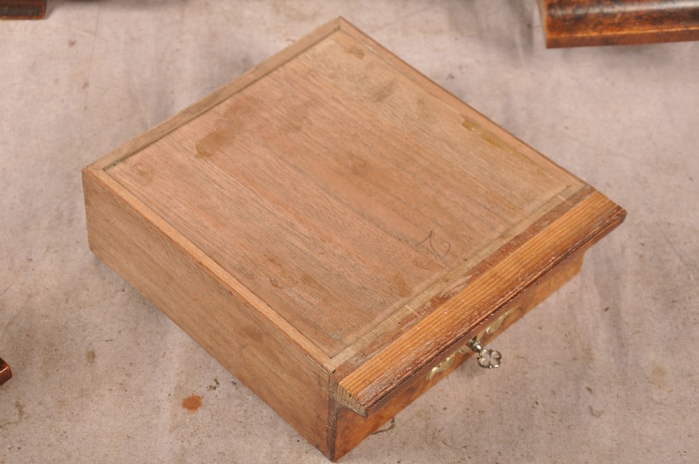 An 18th-century walnut toilet mirror featuring a rectangular adjustable glass frame resting above a three-drawer box base with brass handles. View XII