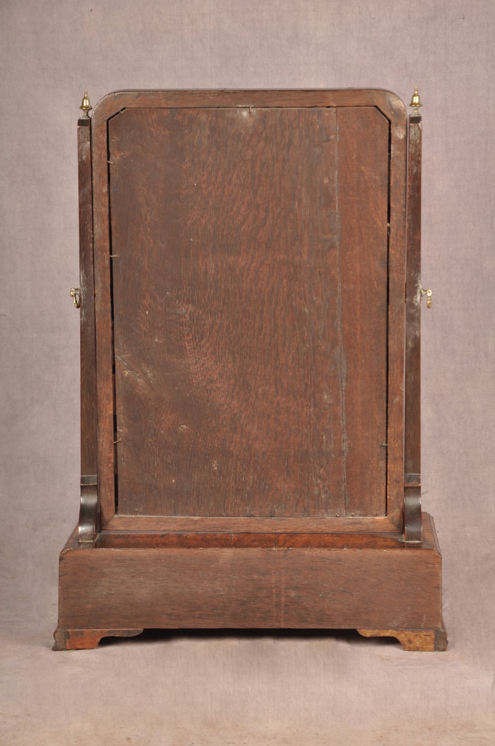 An 18th-century walnut toilet mirror featuring a rectangular adjustable glass frame resting above a three-drawer box base with brass handles. View XVI
