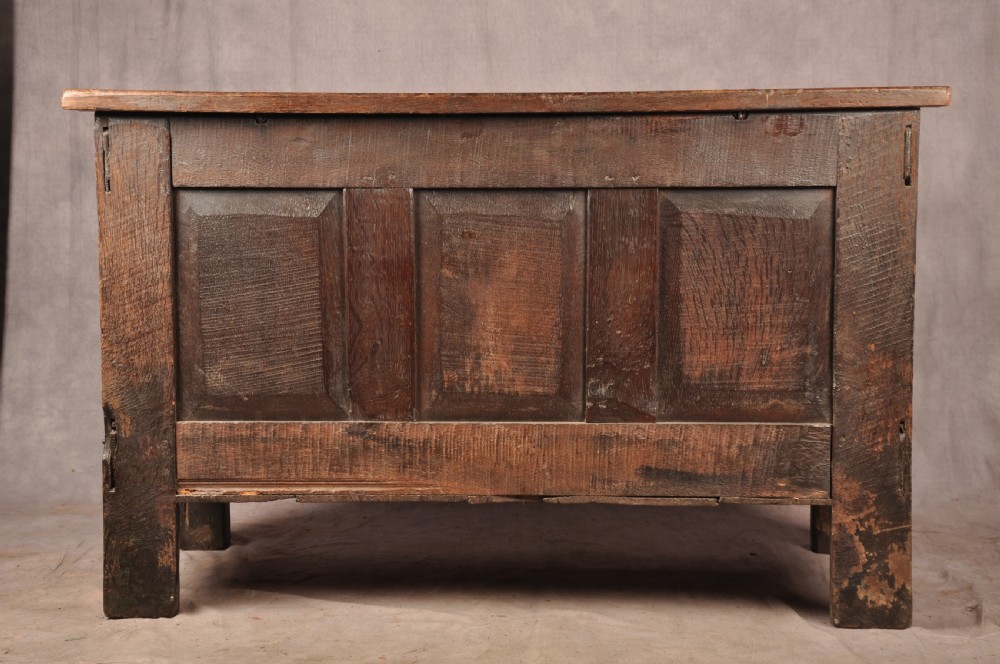 A 17th-century dark oak coffer with three carved arcaded front panels, an upper carved frieze, and a central iron lock plate. View XV