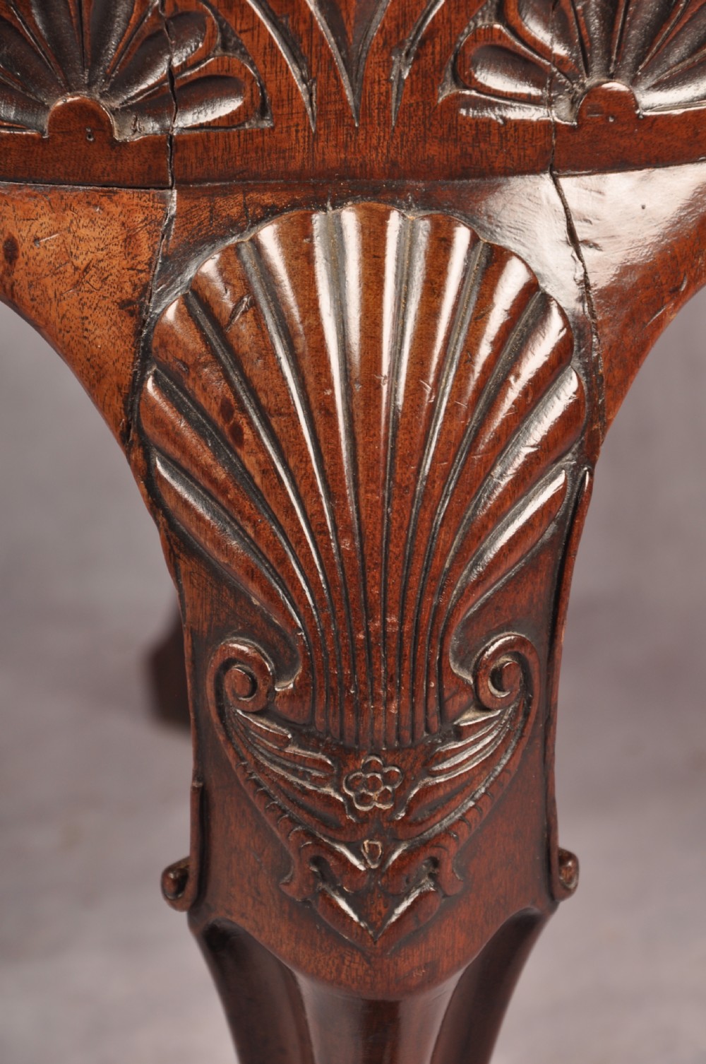 An 18th-century carved mahogany corner desk chair featuring detailed back splats, a shell-carved knee, cabriole legs, and a cream upholstered drop-in seat. View III