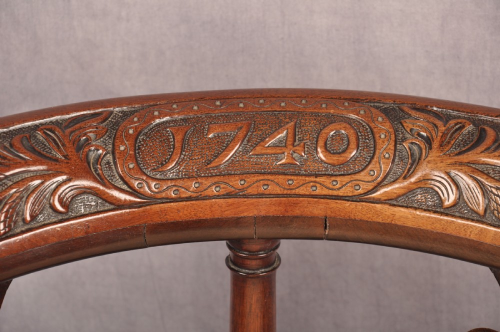 An 18th-century carved mahogany corner desk chair featuring detailed back splats, a shell-carved knee, cabriole legs, and a cream upholstered drop-in seat. View XI