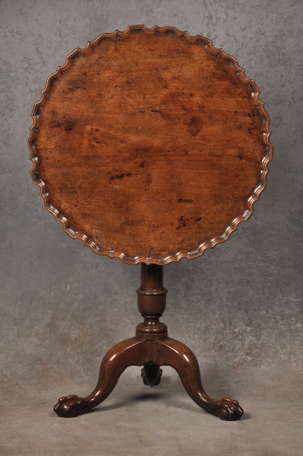An 18th-century mahogany tripod table featuring a circular scalloped piecrust top, a turned column, and three cabriole legs ending in carved feet. View IV