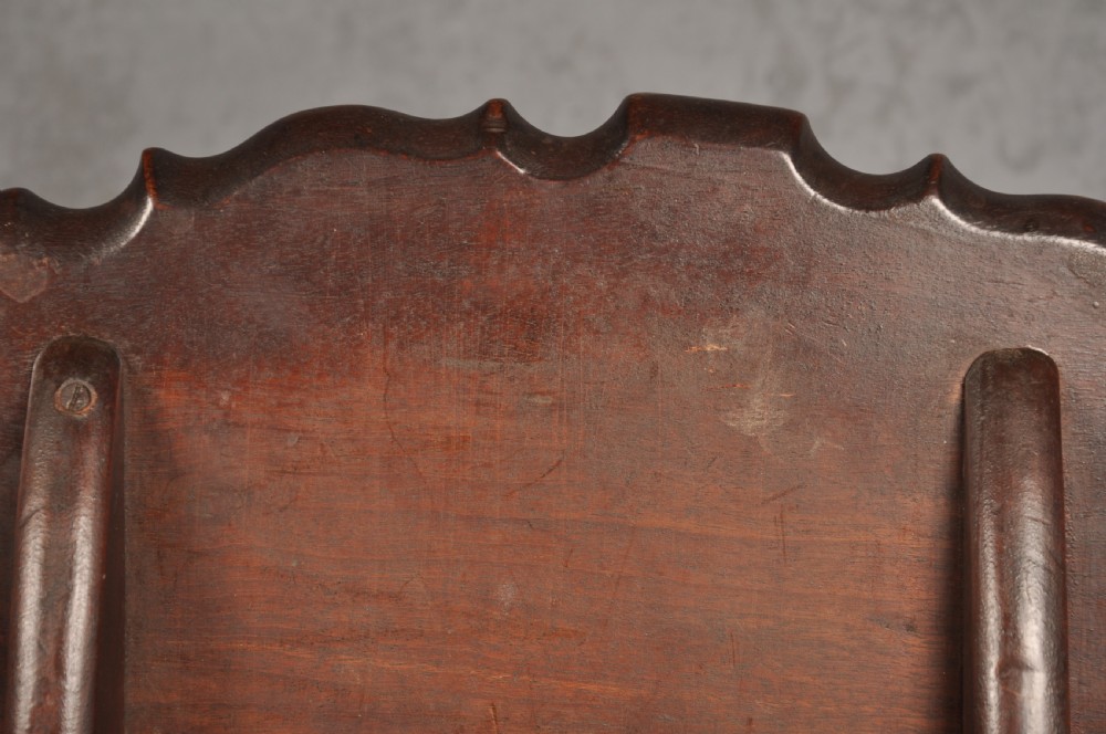 An 18th-century mahogany tripod table featuring a circular scalloped piecrust top, a turned column, and three cabriole legs ending in carved feet. View VI