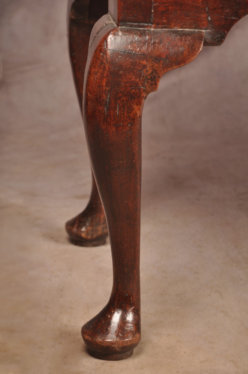 An early 18th-century dark walnut lowboy side table featuring cabriole legs with pad feet, three brass-handled drawers, and a shaped apron. View IX