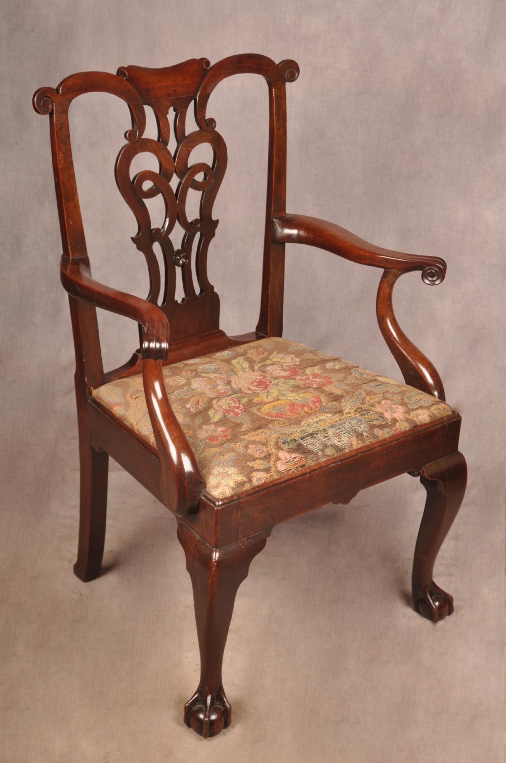 An 18th-century mahogany armchair with a carved pierced splat back, shaped arms, a tapestry-upholstered seat, and cabriole front legs ending in ball and claw feet. View II