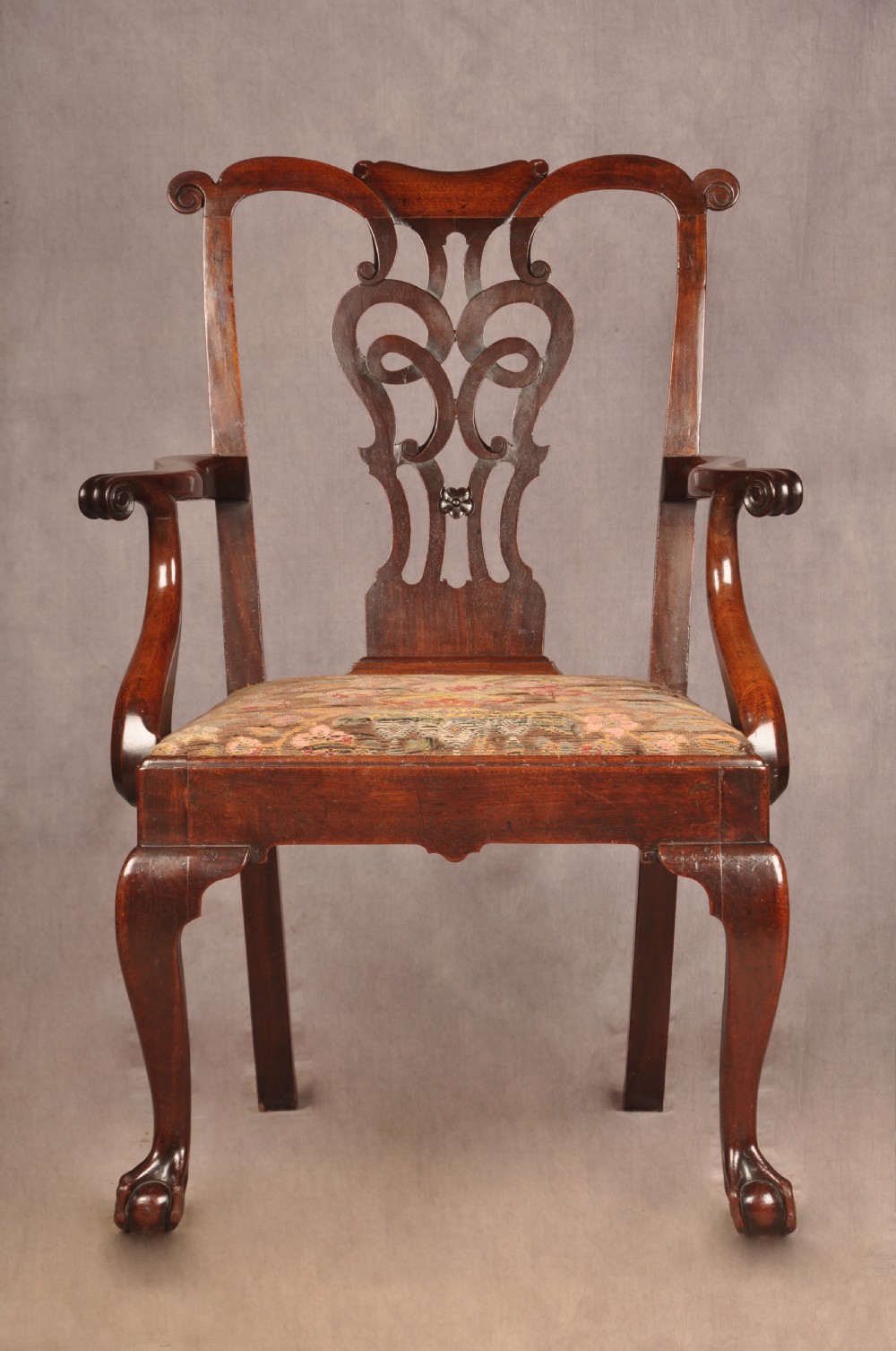 An 18th-century mahogany armchair with a carved pierced splat back, shaped arms, a tapestry-upholstered seat, and cabriole front legs ending in ball and claw feet. View III