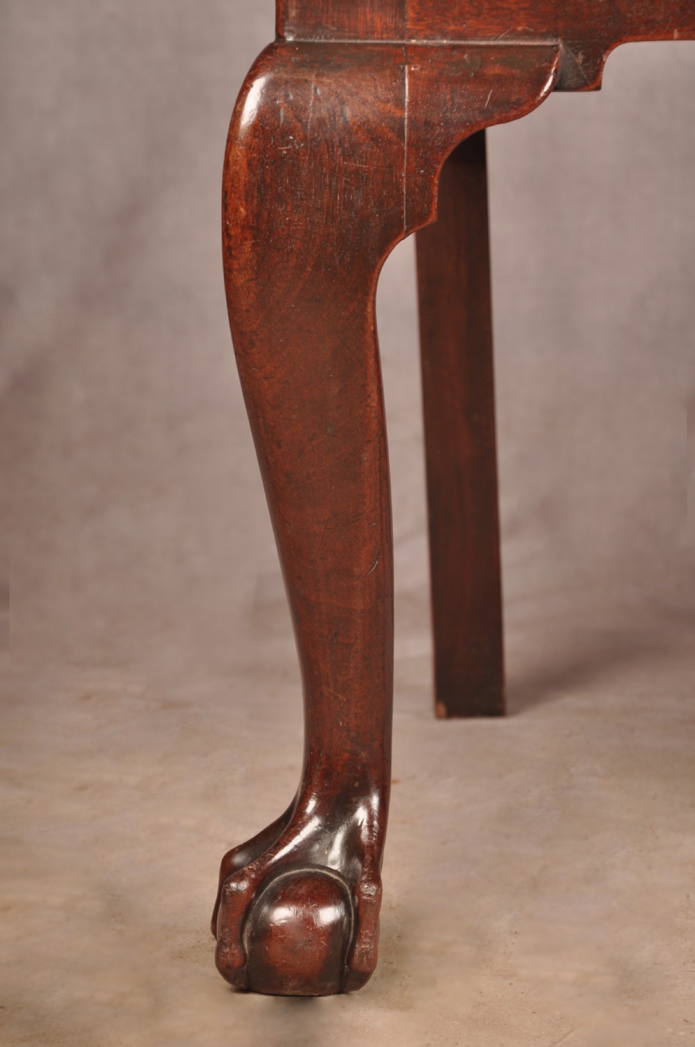 An 18th-century mahogany armchair with a carved pierced splat back, shaped arms, a tapestry-upholstered seat, and cabriole front legs ending in ball and claw feet. View IV