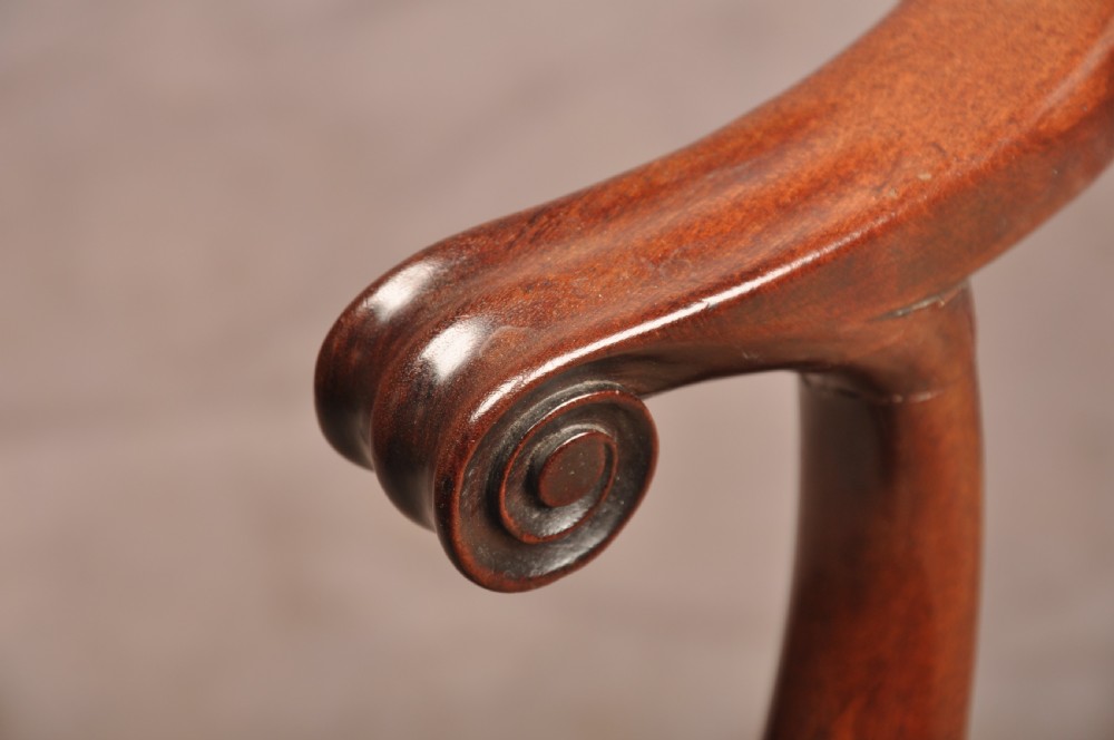 An 18th-century mahogany armchair with a carved pierced splat back, shaped arms, a tapestry-upholstered seat, and cabriole front legs ending in ball and claw feet. View VI