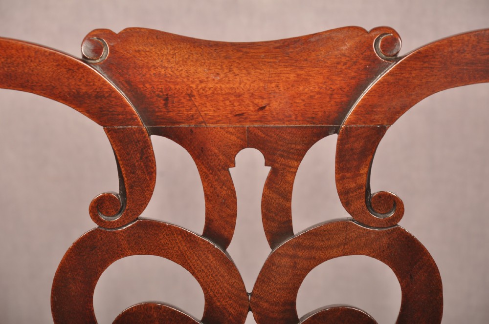 An 18th-century mahogany armchair with a carved pierced splat back, shaped arms, a tapestry-upholstered seat, and cabriole front legs ending in ball and claw feet. View VIII