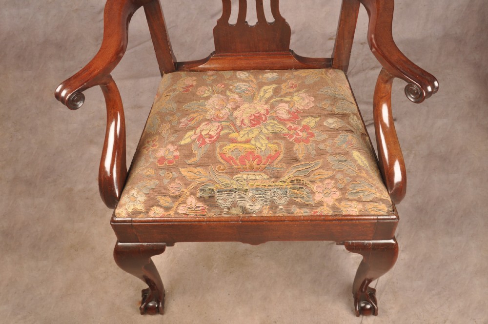 An 18th-century mahogany armchair with a carved pierced splat back, shaped arms, a tapestry-upholstered seat, and cabriole front legs ending in ball and claw feet. View XVII
