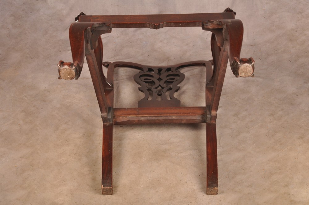 An 18th-century mahogany armchair with a carved pierced splat back, shaped arms, a tapestry-upholstered seat, and cabriole front legs ending in ball and claw feet. View XX