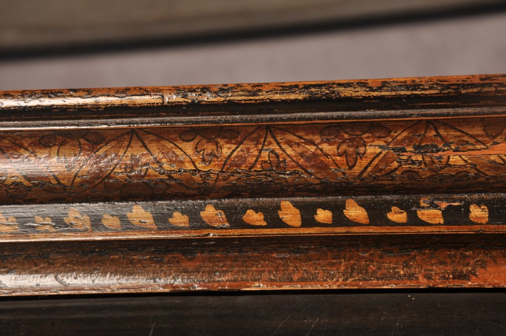 An early eighteenth-century black and gold japanned chest on stand featuring detailed Chinoiserie scenes, multiple brass drop handles, turned legs, and a shaped stretcher. View XXIII
