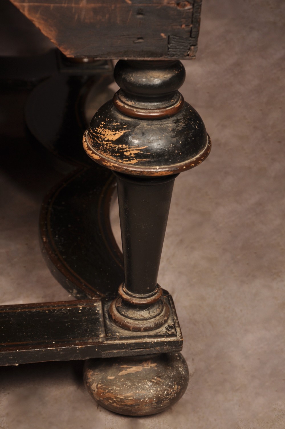 An early eighteenth-century black and gold japanned chest on stand featuring detailed Chinoiserie scenes, multiple brass drop handles, turned legs, and a shaped stretcher. View XXVI