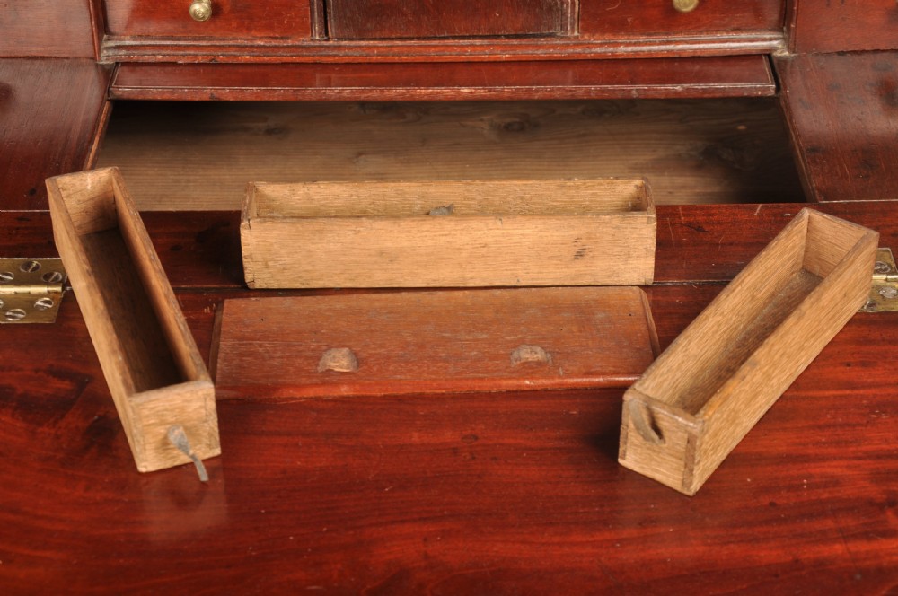 An early 18th-century mahogany slope-front bureau with three graduated drawers, brass handles, keyhole escutcheons, and bracket feet. View VIII