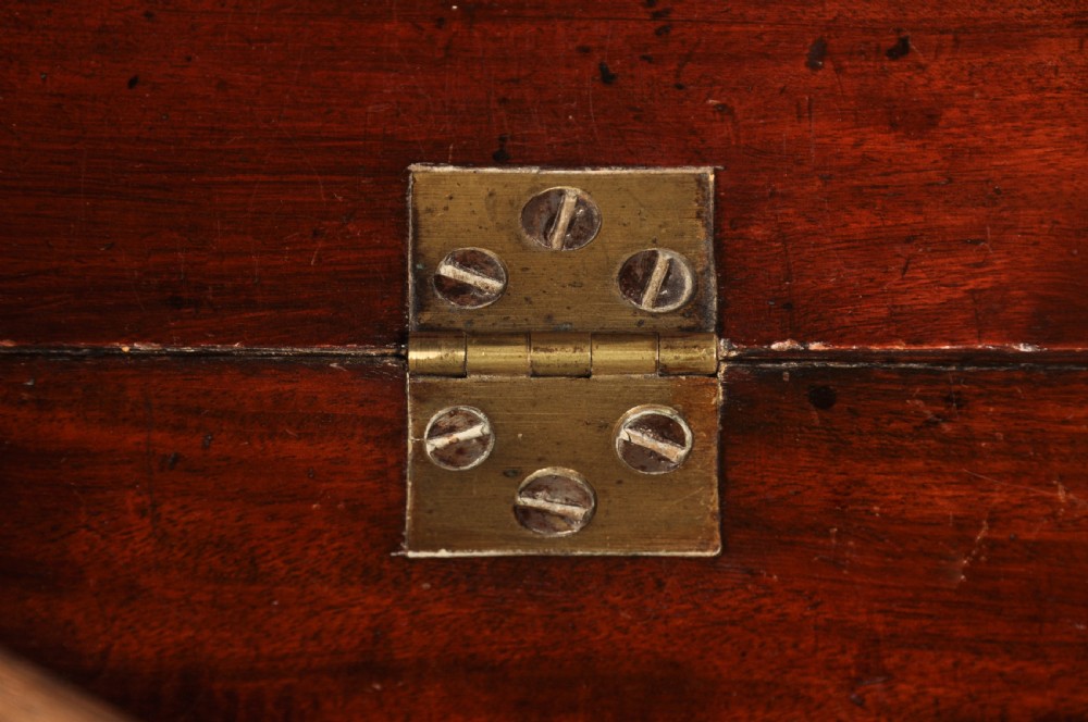 An early 18th-century mahogany slope-front bureau with three graduated drawers, brass handles, keyhole escutcheons, and bracket feet. View X