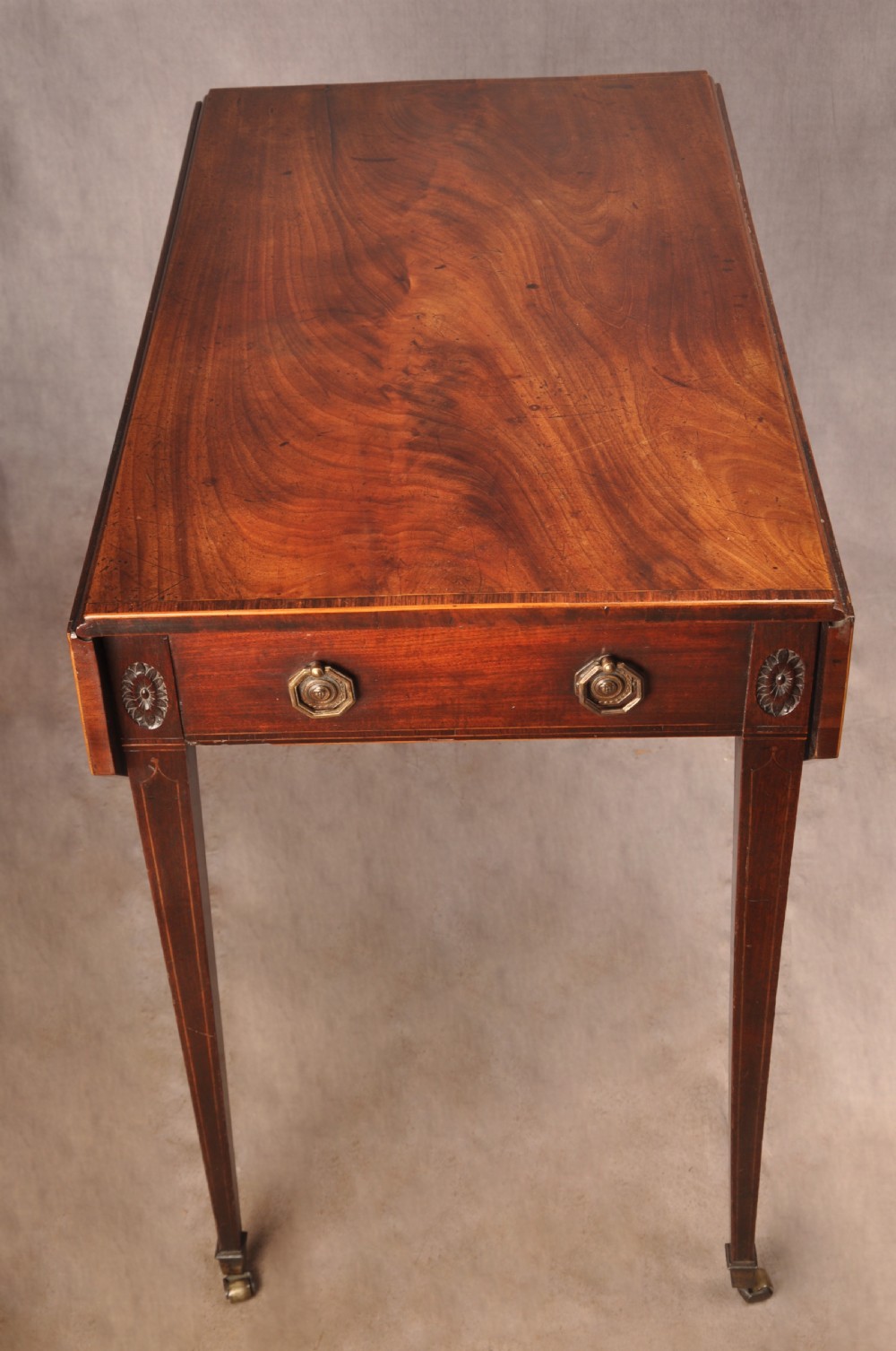 A late 18th-century mahogany Pembroke table with drop-leaf sides, square tapered legs on castors, and a single drawer with octagonal brass handles. View VII