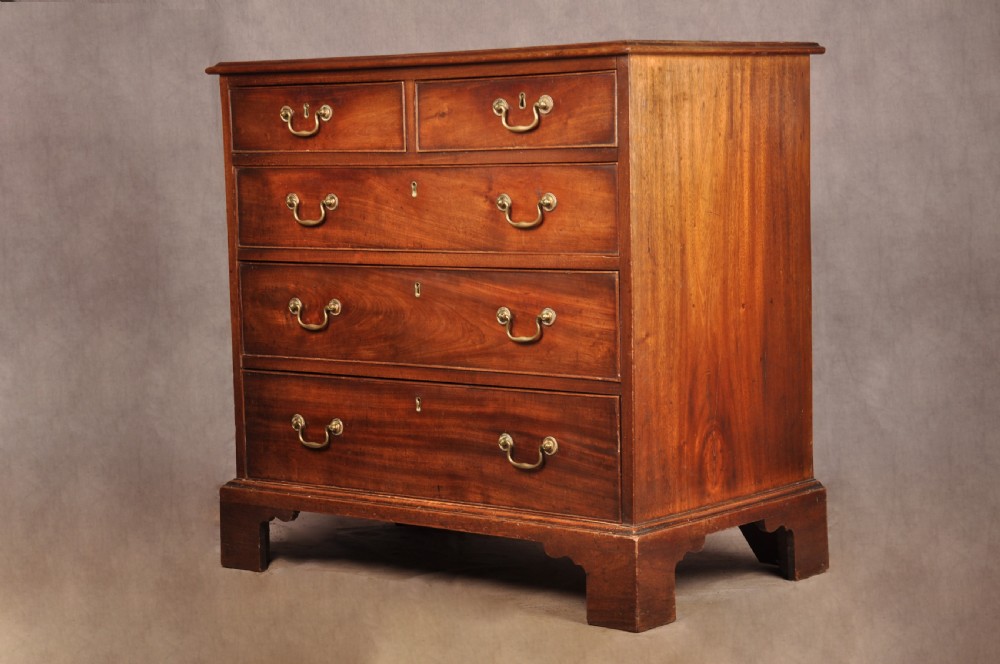 An 18th-century Georgian mahogany chest of drawers featuring two short over three long graduated drawers with brass swan-neck handles and bracket feet. View III