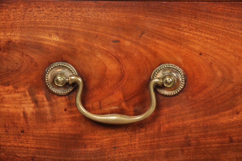 An 18th-century Georgian mahogany chest of drawers featuring two short over three long graduated drawers with brass swan-neck handles and bracket feet. View VIII