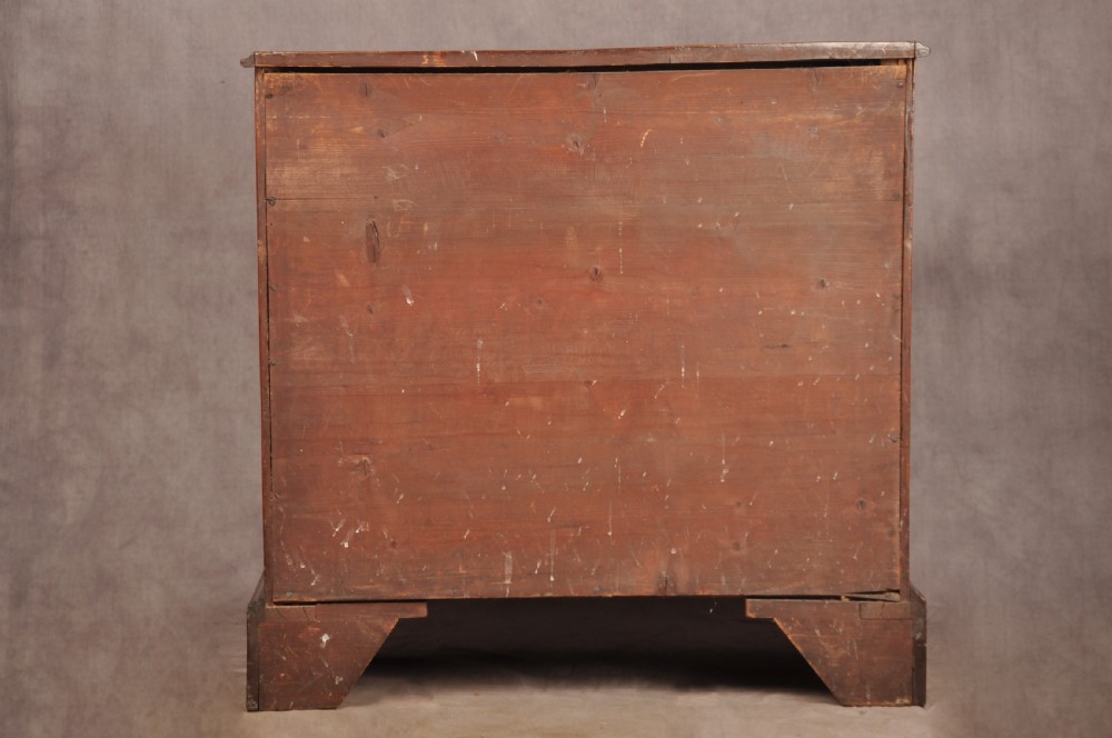 An 18th-century Georgian mahogany chest of drawers featuring two short over three long graduated drawers with brass swan-neck handles and bracket feet. View XIII