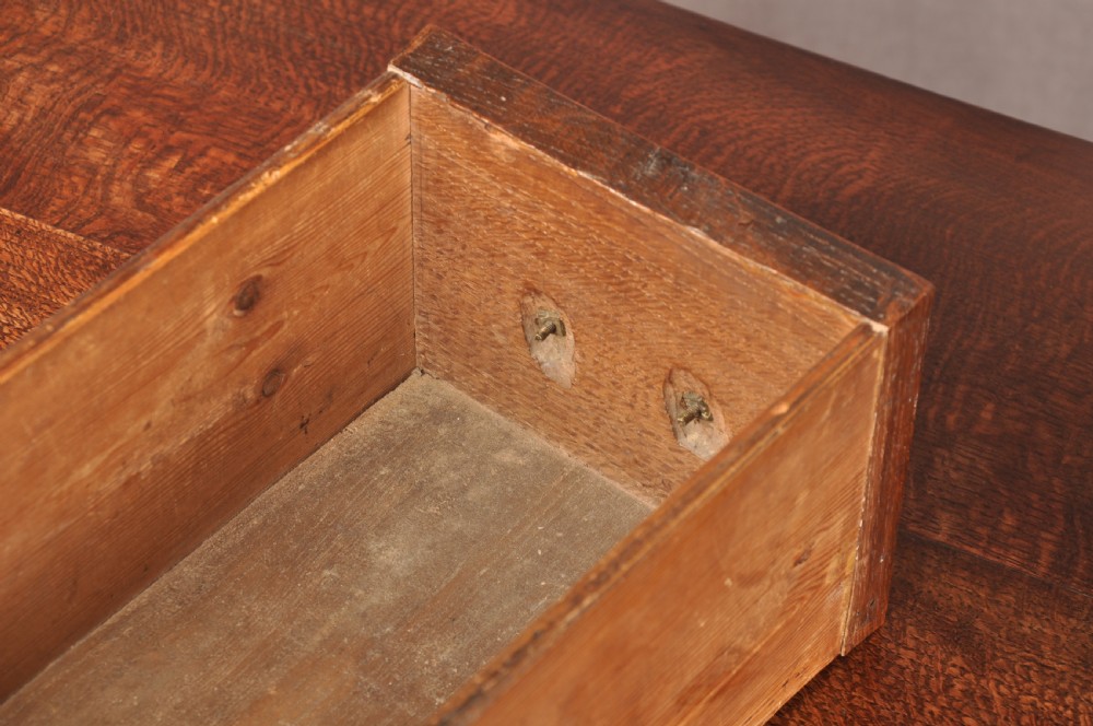 A mid-18th century George II oak lowboy side table featuring three drawers with brass handles, a shaped scroll apron, and cabriole legs ending in pad feet. View VIII