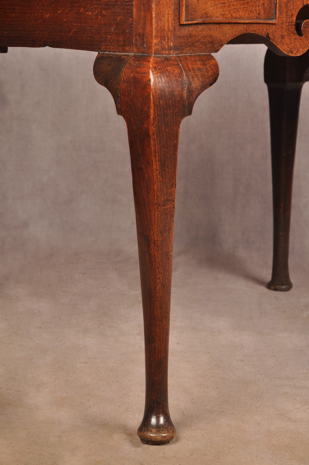 A mid-18th century George II oak lowboy side table featuring three drawers with brass handles, a shaped scroll apron, and cabriole legs ending in pad feet. View IX