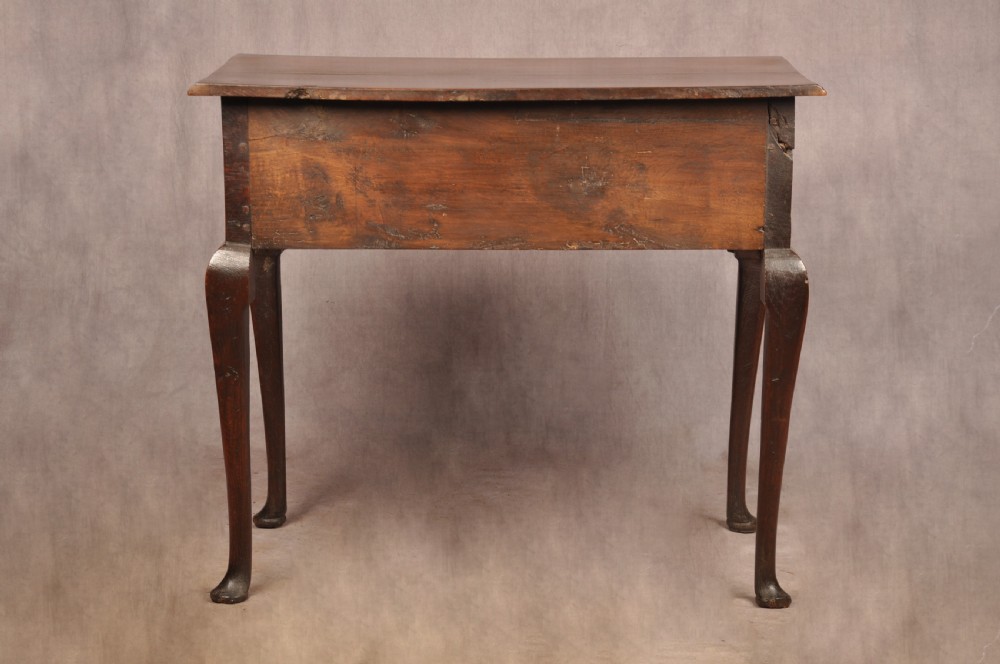 A mid-18th century George II oak lowboy side table featuring three drawers with brass handles, a shaped scroll apron, and cabriole legs ending in pad feet. View XIII