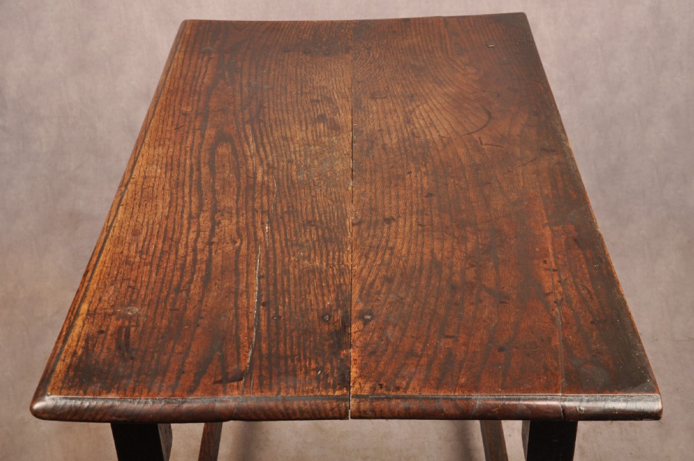A 17th-century dark oak side table featuring a single drawer with a brass handle, turned legs, and a perimeter box stretcher. View VIII