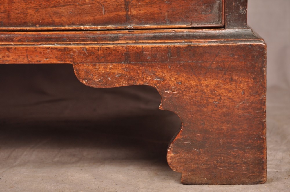 An eighteenth-century mahogany chest of drawers featuring four graduated drawers with brass swan-neck handles, a brushing slide, and bracket feet. View VIII
