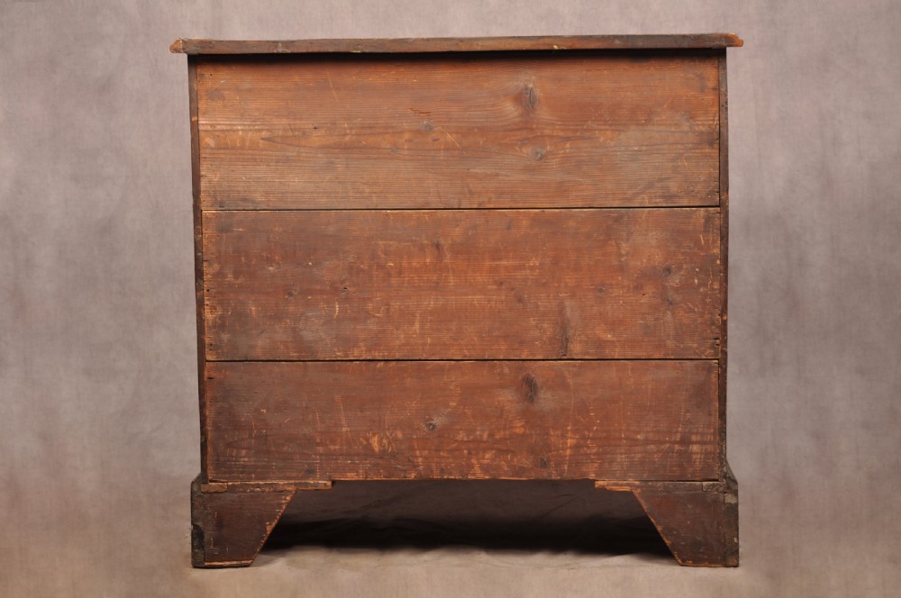 An eighteenth-century mahogany chest of drawers featuring four graduated drawers with brass swan-neck handles, a brushing slide, and bracket feet. View XIII