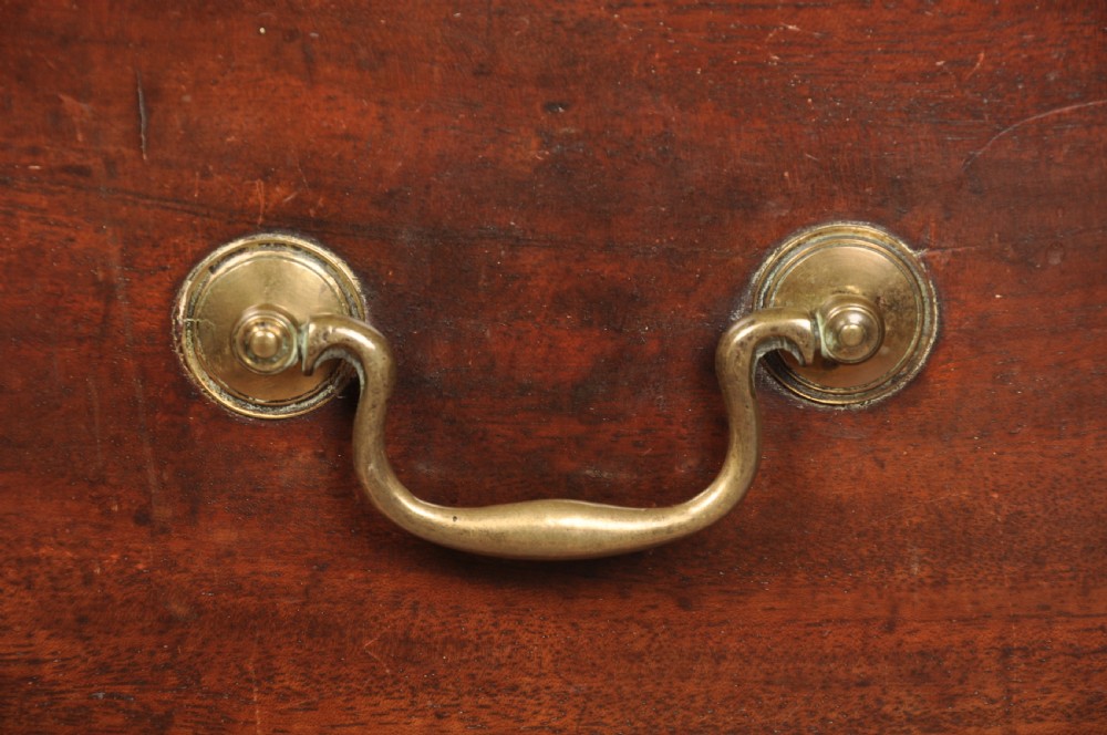 An eighteenth-century mahogany chest of drawers featuring four graduated drawers with brass swan-neck handles, a brushing slide, and bracket feet. View XIV