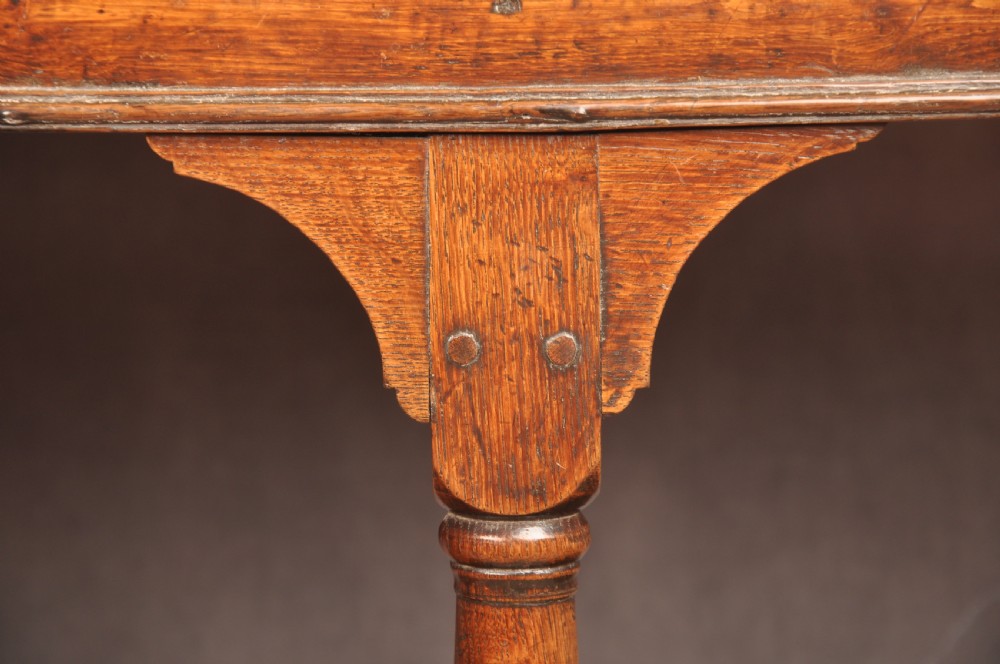 An 18th-century oak pot board dresser featuring an open tiered plate rack above three drawers with brass handles and a low shelf. View IX