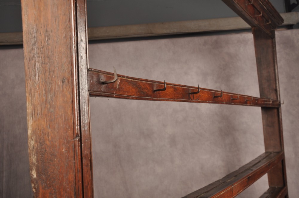 An 18th-century oak pot board dresser featuring an open tiered plate rack above three drawers with brass handles and a low shelf. View XIII