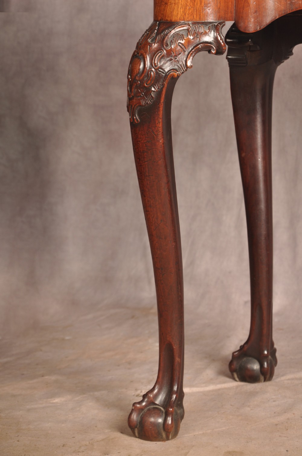 An 18th-century George II mahogany card table with a fold-over shaped top, a frieze drawer, and carved cabriole legs with claw-and-ball feet. View IV