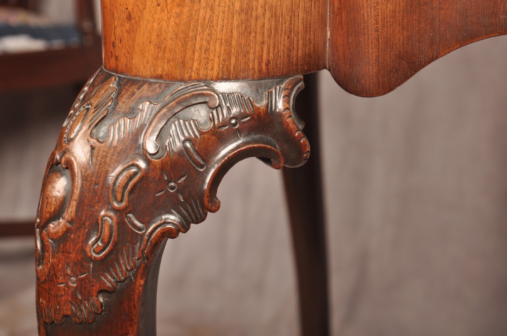 An 18th-century George II mahogany card table with a fold-over shaped top, a frieze drawer, and carved cabriole legs with claw-and-ball feet. View VII