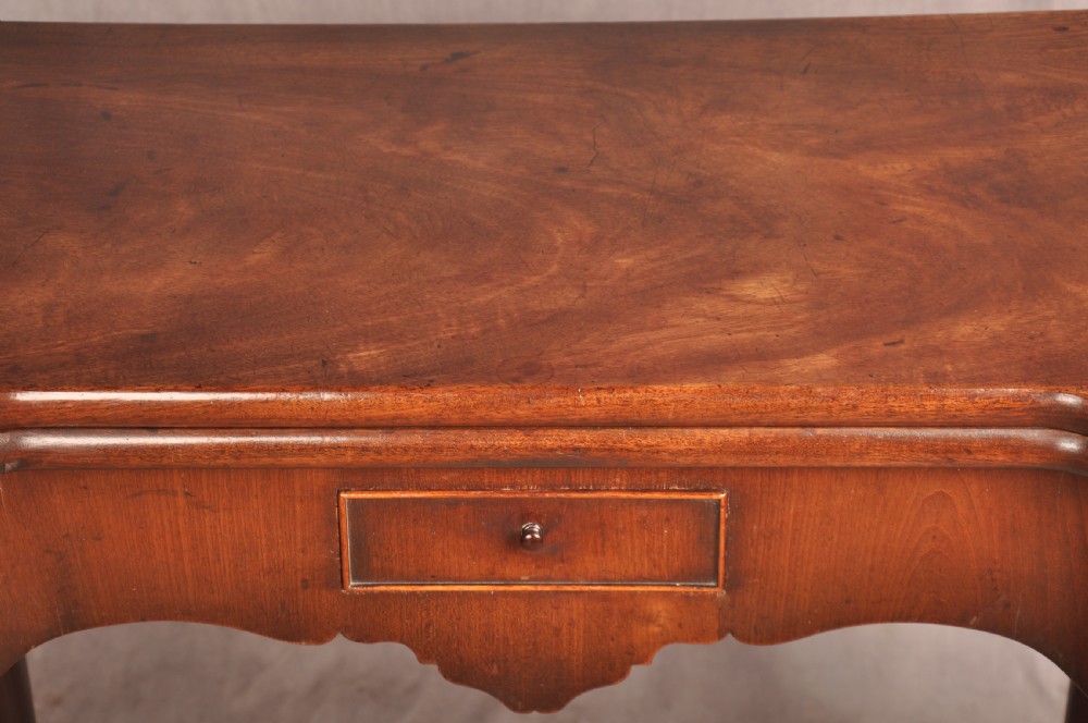 An 18th-century George II mahogany card table with a fold-over shaped top, a frieze drawer, and carved cabriole legs with claw-and-ball feet. View XI