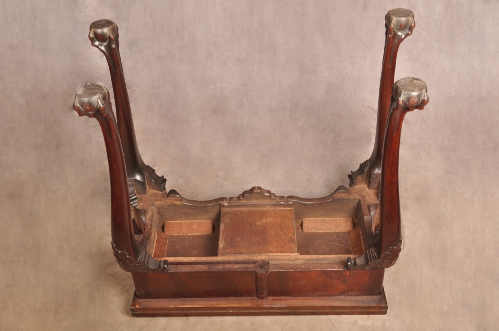 An 18th-century George II mahogany card table with a fold-over shaped top, a frieze drawer, and carved cabriole legs with claw-and-ball feet. View XVIII