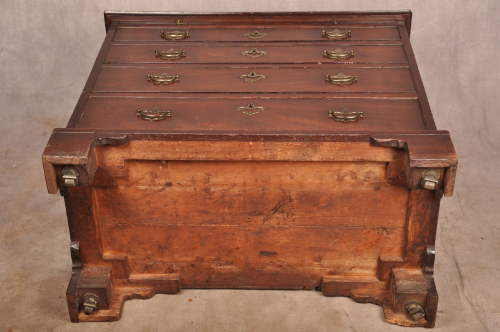 An early eighteenth-century mahogany chest of drawers featuring four graduated drawers, brass handles, a brushing slide, and bracket feet. View XVII