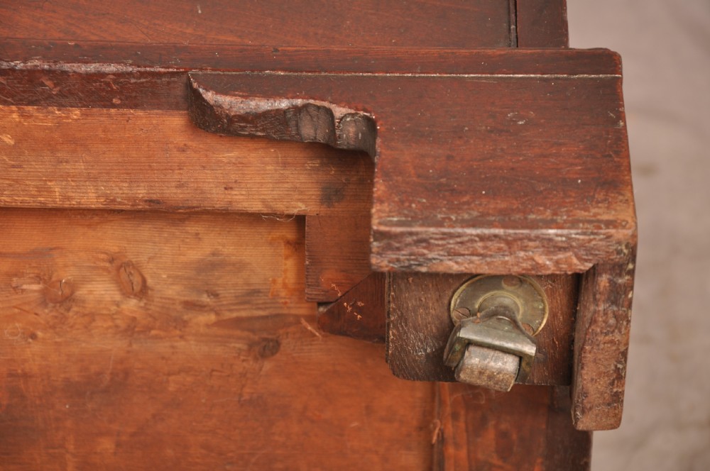 An early eighteenth-century mahogany chest of drawers featuring four graduated drawers, brass handles, a brushing slide, and bracket feet. View XVIII